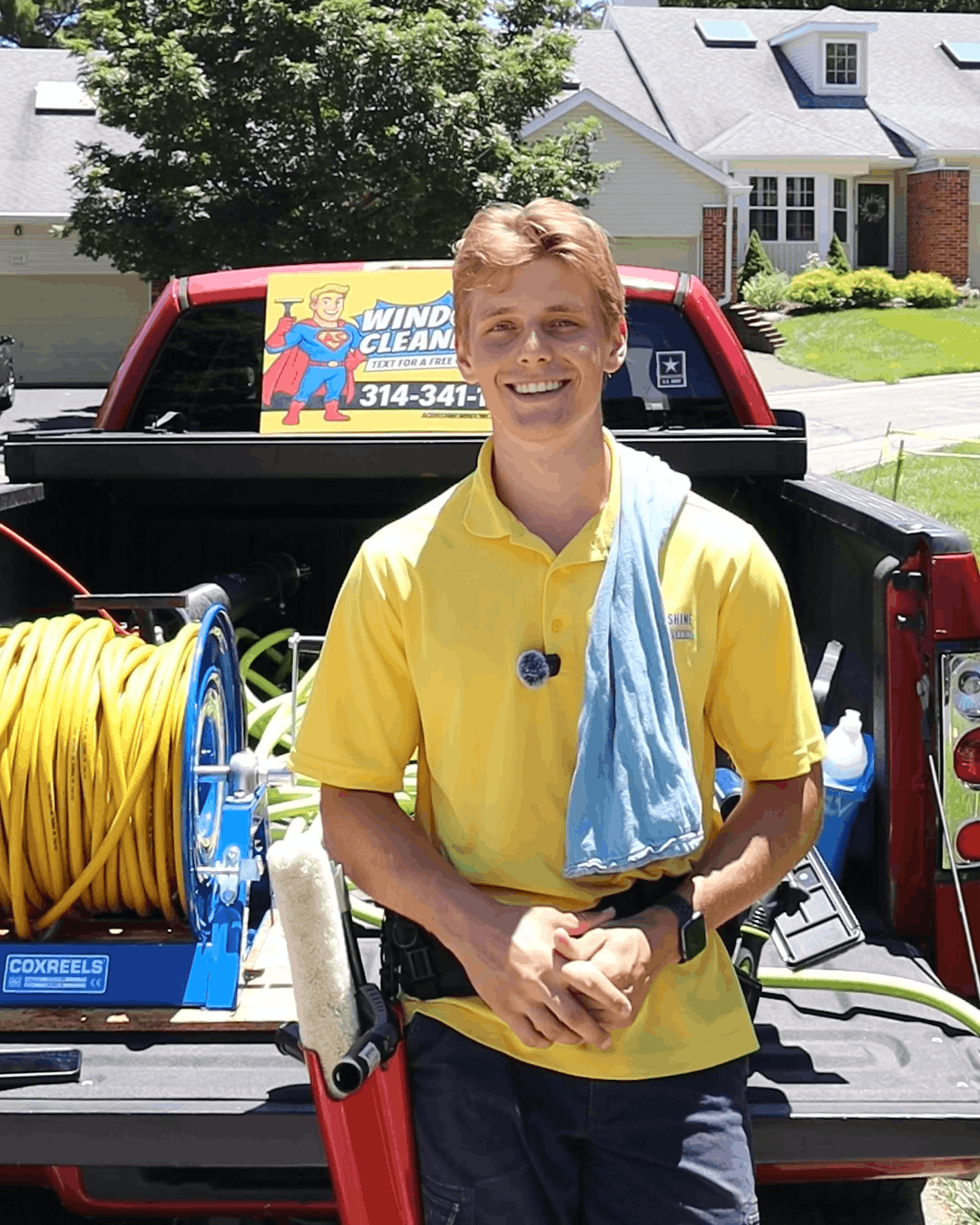 Professional window cleaner squeegeeing a window